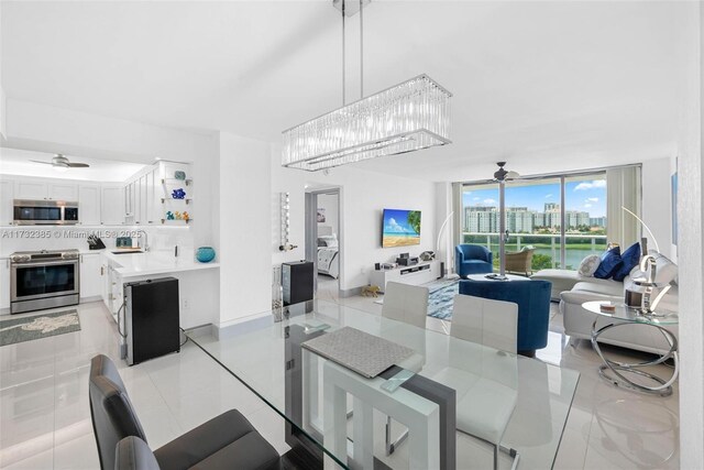3675 N Country Club Dr Unit 1006, Aventura, FL 33180 - dining space featuring a ceiling fan, a wall of windows, a chandelier, and light tile patterned flooring