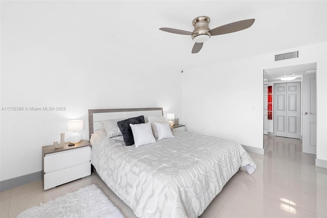 tiled bedroom featuring ceiling fan