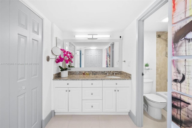 full bathroom with tiled shower / bath combo, vanity, tile patterned flooring, and toilet