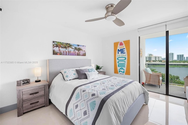 bedroom with ceiling fan, access to exterior, a water view, expansive windows, and light tile patterned flooring