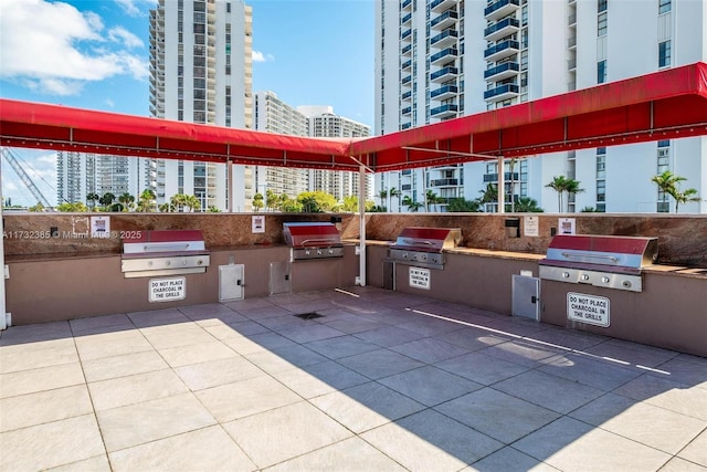 3675 N Country Club Dr Unit 1006, Aventura, FL 33180 - view of patio featuring area for grilling and a city view