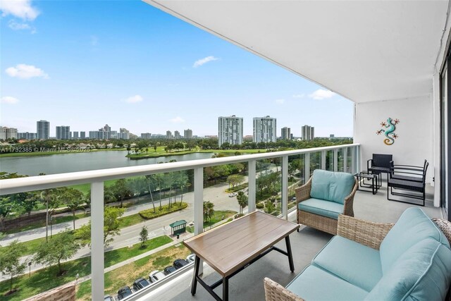 balcony featuring a water view and an outdoor hangout area