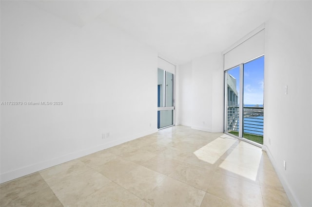 empty room featuring baseboards