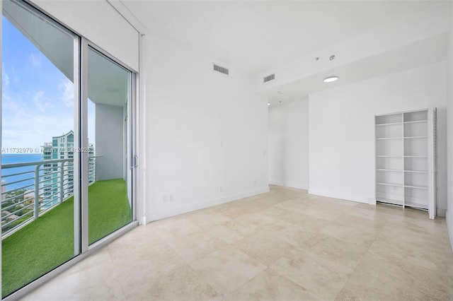 unfurnished room with visible vents and light tile patterned floors