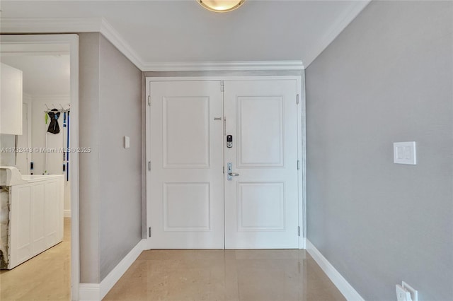 foyer with crown molding and washer and dryer