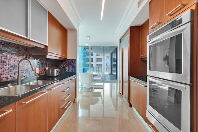 kitchen with stainless steel double oven, sink, tasteful backsplash, and crown molding