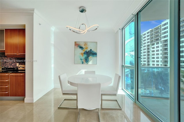 tiled dining area featuring crown molding and an inviting chandelier