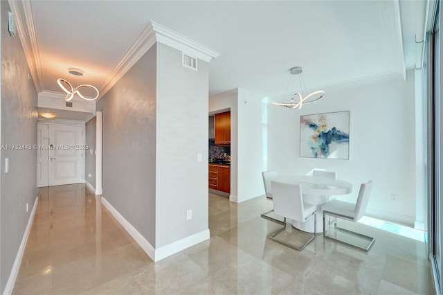 hallway with crown molding and an inviting chandelier