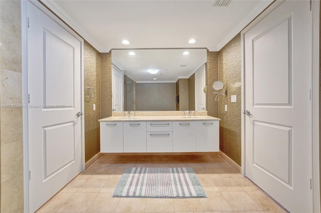 bathroom with tile patterned floors, ornamental molding, and vanity