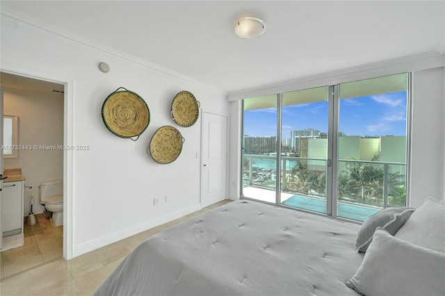 bedroom featuring light tile patterned floors, crown molding, a wall of windows, ensuite bathroom, and access to outside