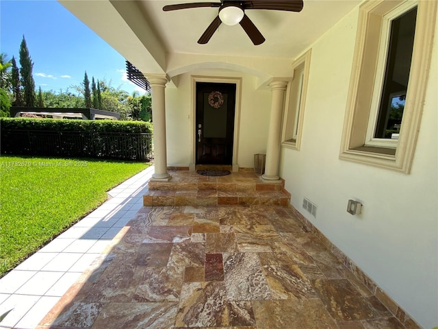 doorway to property with a yard and ceiling fan