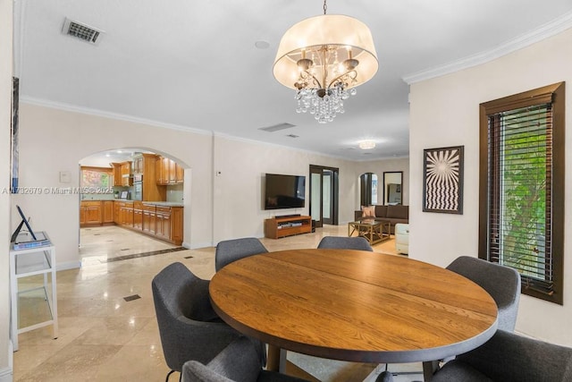 dining area featuring a notable chandelier and crown molding