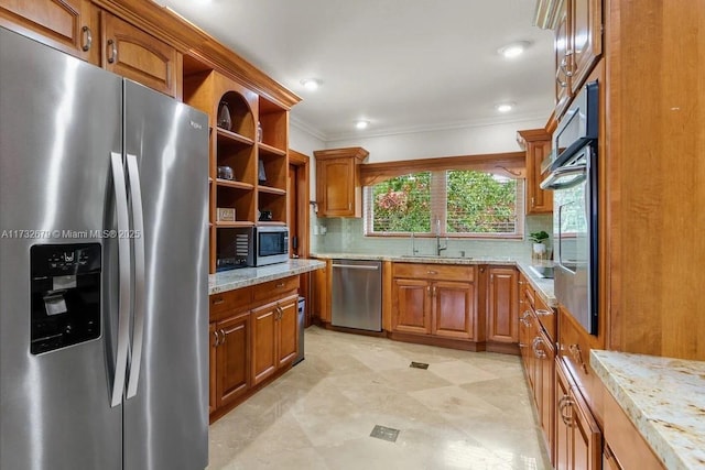 kitchen featuring appliances with stainless steel finishes, tasteful backsplash, sink, crown molding, and light stone countertops