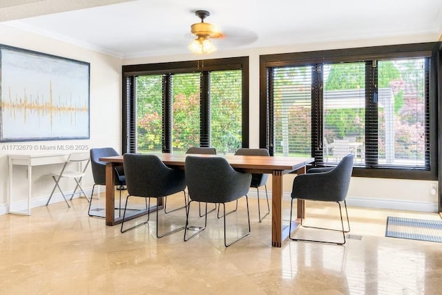 dining area featuring plenty of natural light and ornamental molding