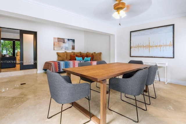 dining space with ceiling fan and ornamental molding