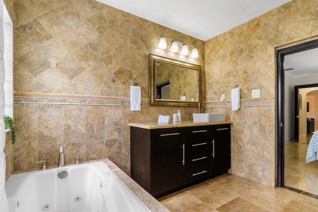 bathroom featuring tile walls, vanity, crown molding, and tiled bath