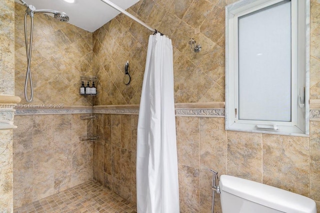 bathroom with a shower with curtain and toilet