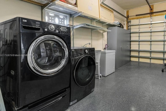 clothes washing area with washing machine and clothes dryer