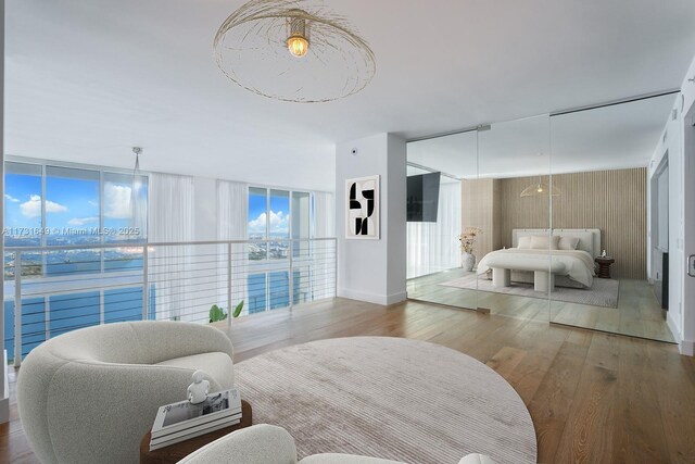 living room with a wall of windows and hardwood / wood-style floors