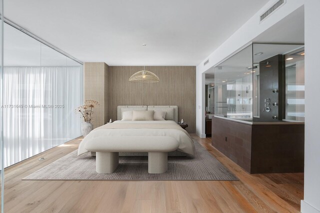 interior space featuring vanity, hardwood / wood-style floors, and walk in shower