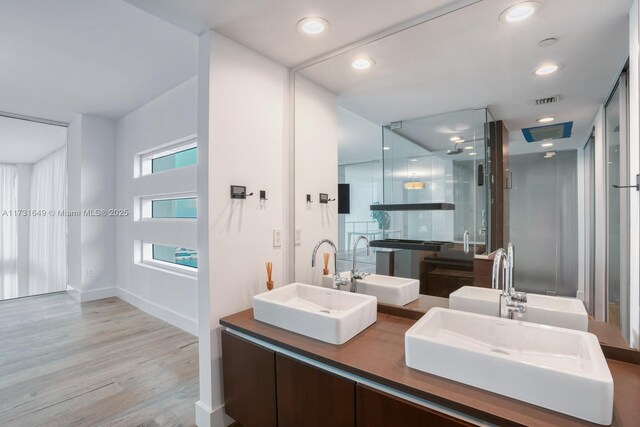 laundry area with stacked washing maching and dryer, electric panel, and light tile patterned floors