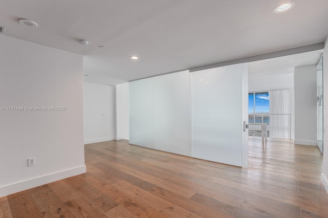 spare room with light wood-type flooring