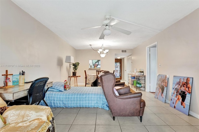 bedroom featuring light tile patterned flooring, ceiling fan with notable chandelier, and a textured ceiling