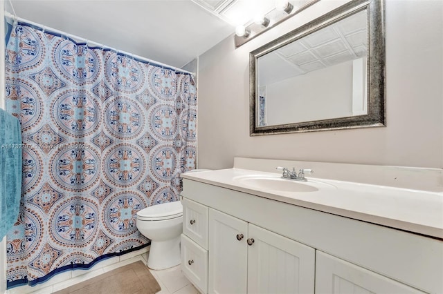 bathroom featuring vanity, tile patterned floors, and toilet