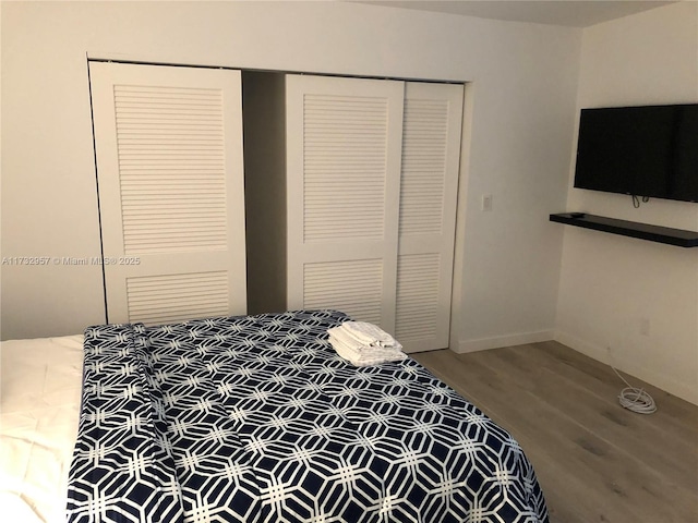 bedroom with hardwood / wood-style flooring and a closet