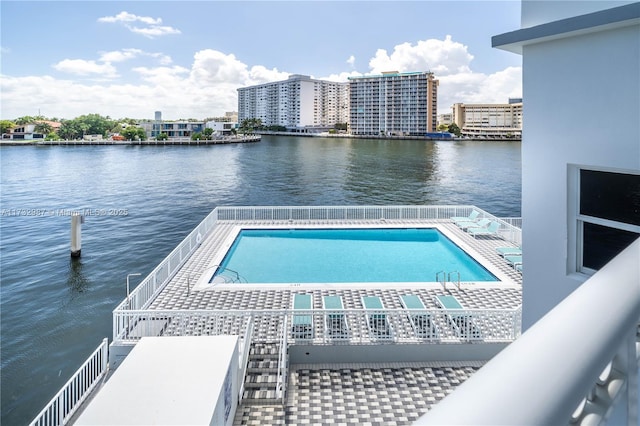 view of swimming pool with a water view