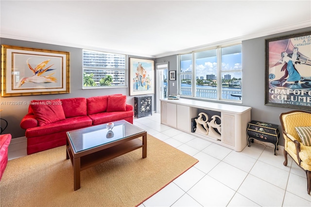 living room featuring ornamental molding, a water view, and light tile patterned flooring