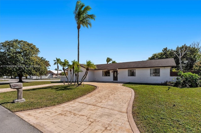 ranch-style home featuring a front yard