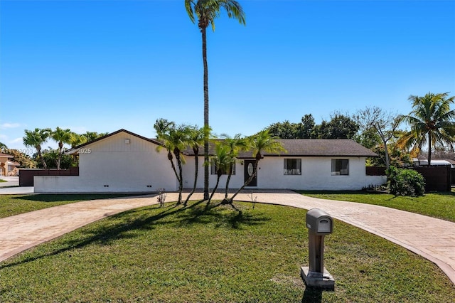 ranch-style house with a front lawn