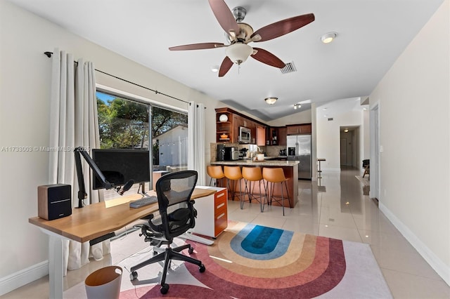 tiled office space with lofted ceiling and ceiling fan