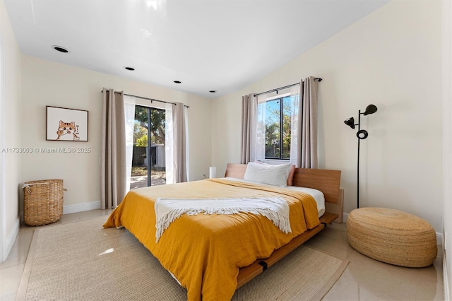 bedroom with access to outside and light tile patterned flooring