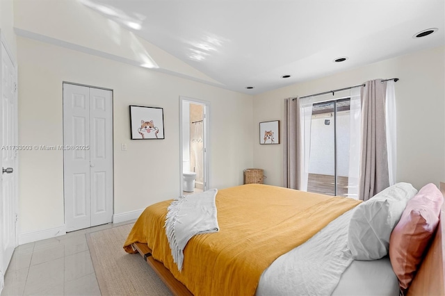 tiled bedroom with connected bathroom and vaulted ceiling