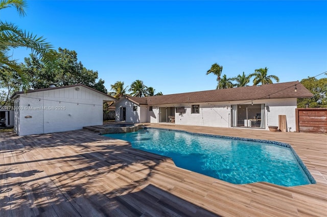 view of swimming pool with an in ground hot tub and a deck