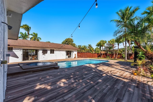 view of swimming pool with a deck