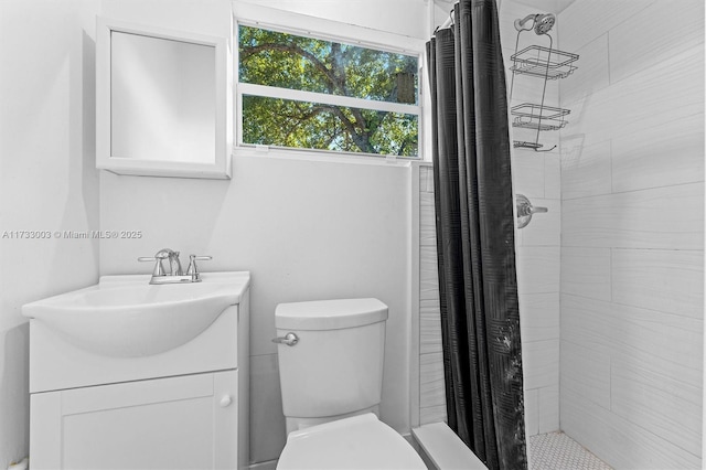 bathroom featuring walk in shower, vanity, and toilet