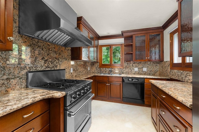 kitchen with a sink, dishwasher, wall chimney exhaust hood, gas stove, and glass insert cabinets