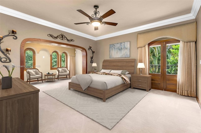 bedroom with arched walkways, light carpet, and crown molding