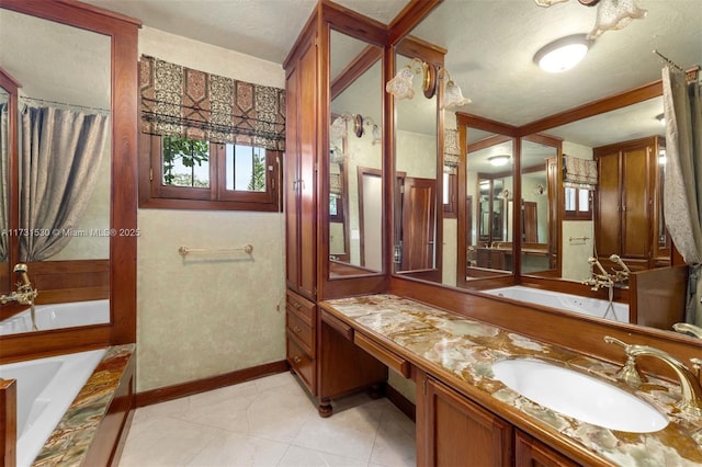 full bathroom with a tub to relax in, baseboards, a textured ceiling, and vanity