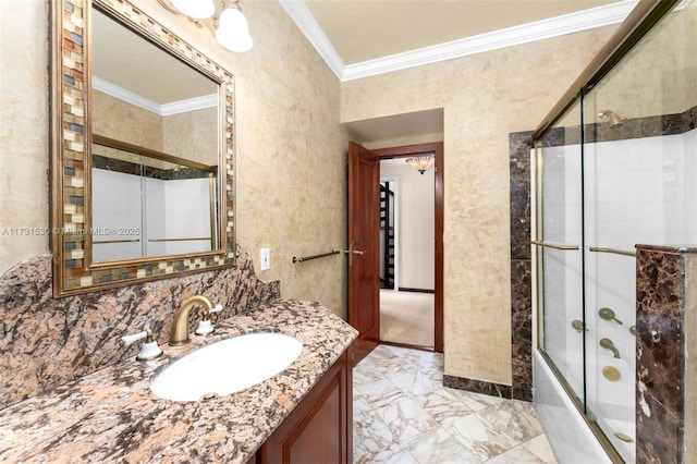 full bath with crown molding, marble finish floor, shower / bath combination with glass door, and vanity