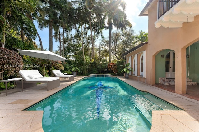 view of swimming pool with a patio area and a fenced in pool