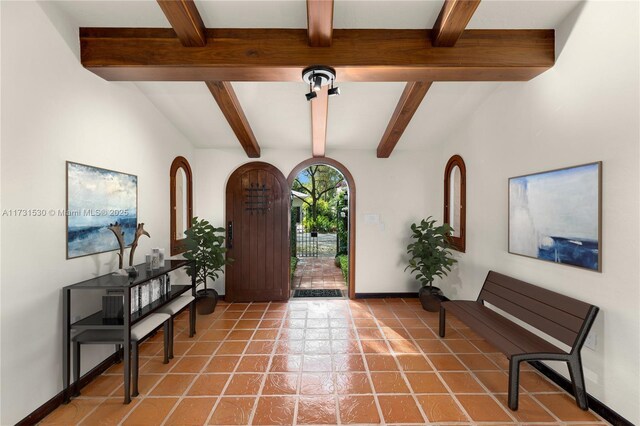 225 Alesio Ave, Coral Gables, FL 33134 - entryway with light tile patterned flooring, baseboards, and beamed ceiling