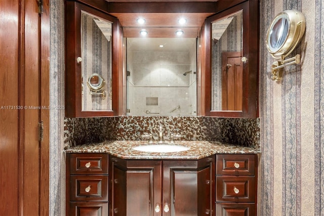 full bath featuring a shower, recessed lighting, vanity, and decorative backsplash