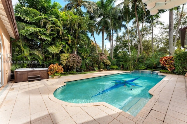 pool featuring a patio area and a hot tub