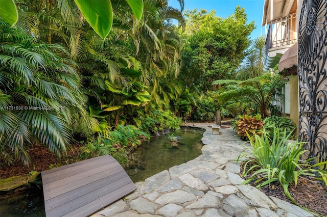 225 Alesio Ave, Coral Gables, FL 33134 - view of yard with a balcony and a small pond