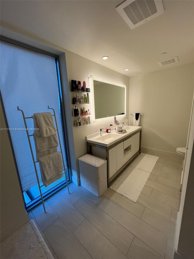 bathroom featuring vanity and toilet