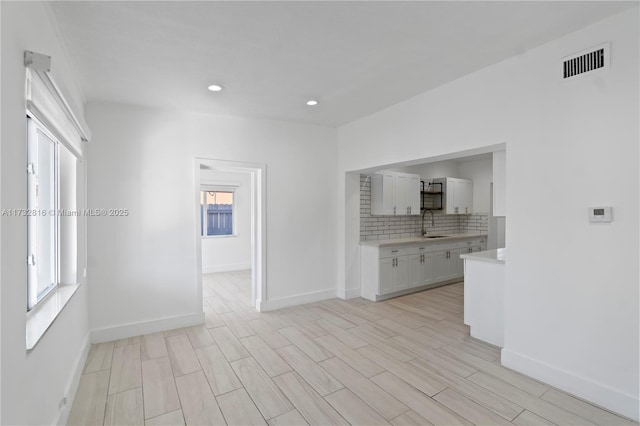 interior space with light hardwood / wood-style floors and sink